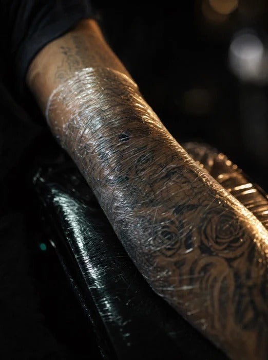 Forearm wrapped in cling film over the numbing cream while it activates